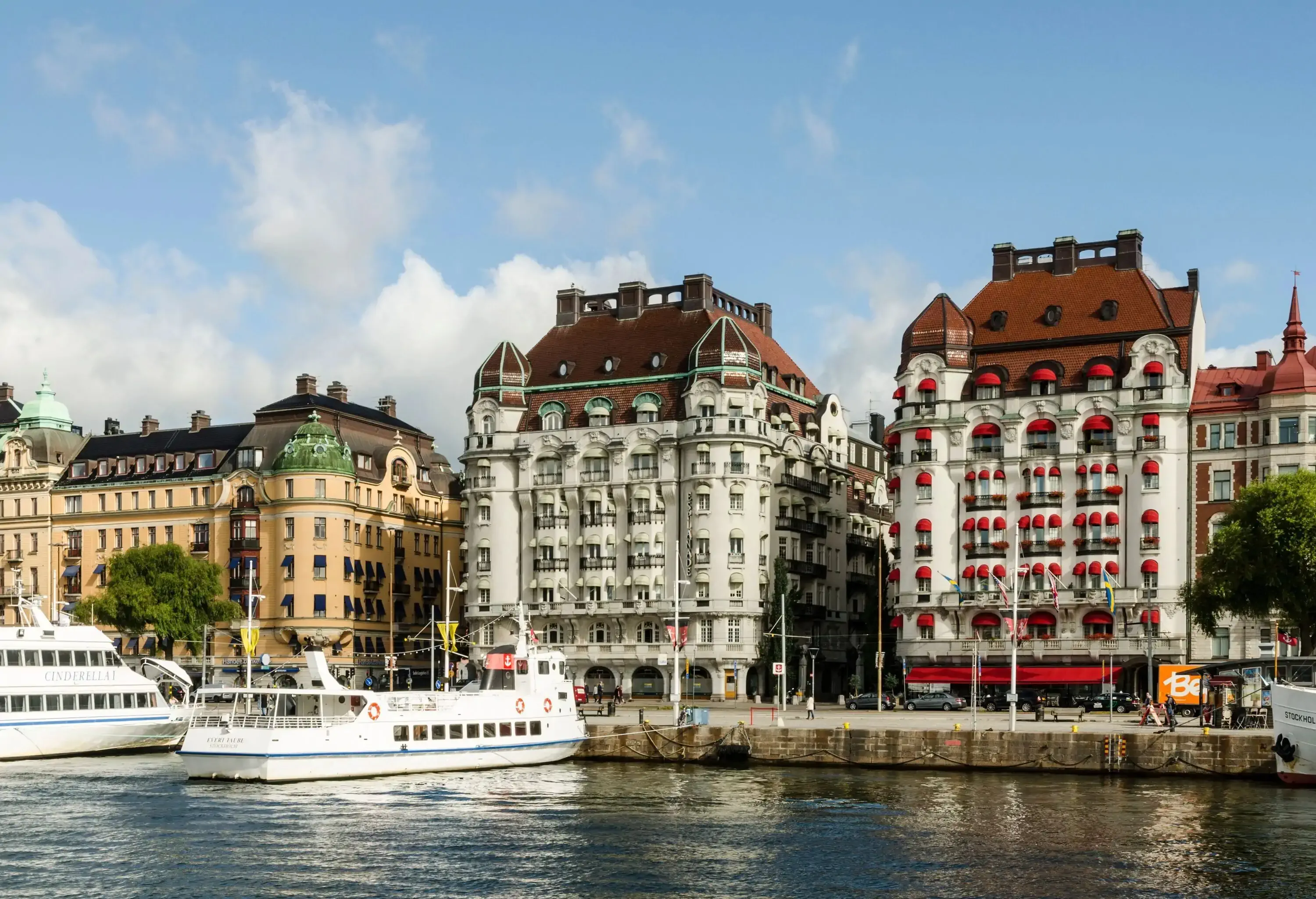 Luxurious hotel buildings overlooking the boats moored in a harbour.