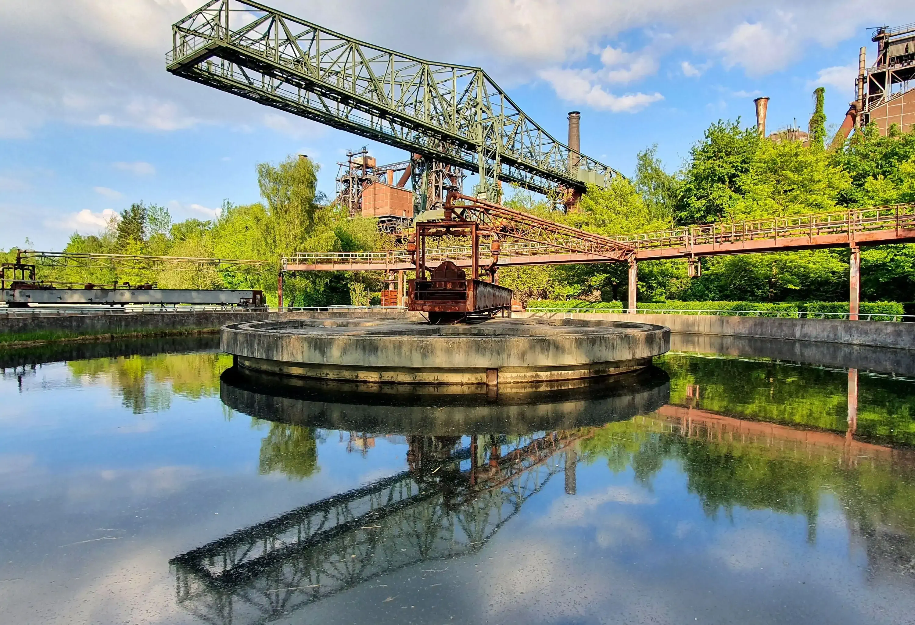 The ore loading bridge with reflection in the clarifier in the Duisburg Landscape Park industrial complex