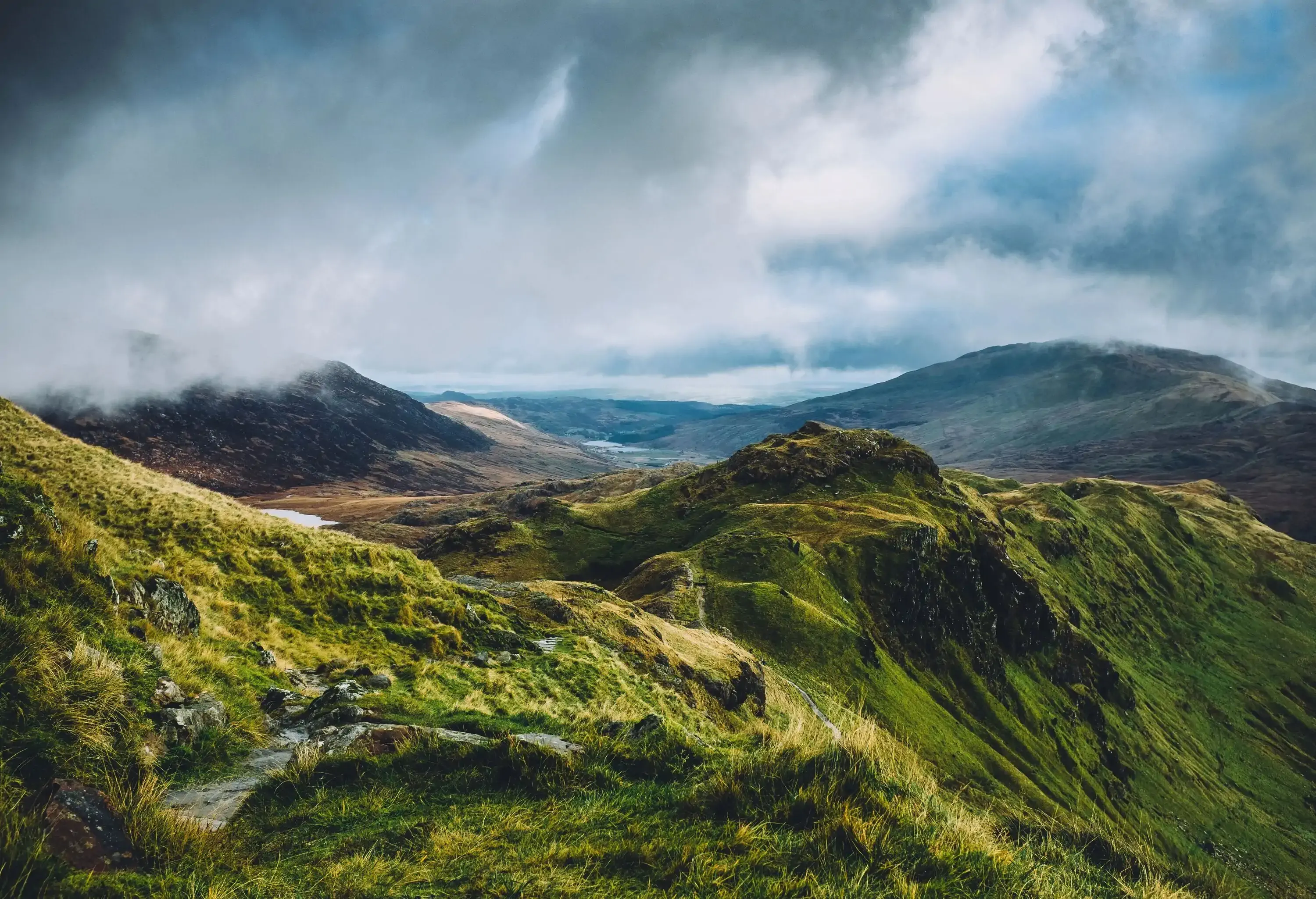 Looking down at Snowdonia national park from the start of the Crib Goch ridge on Mount Snowdon in Wales on a cloudy Autumn day.