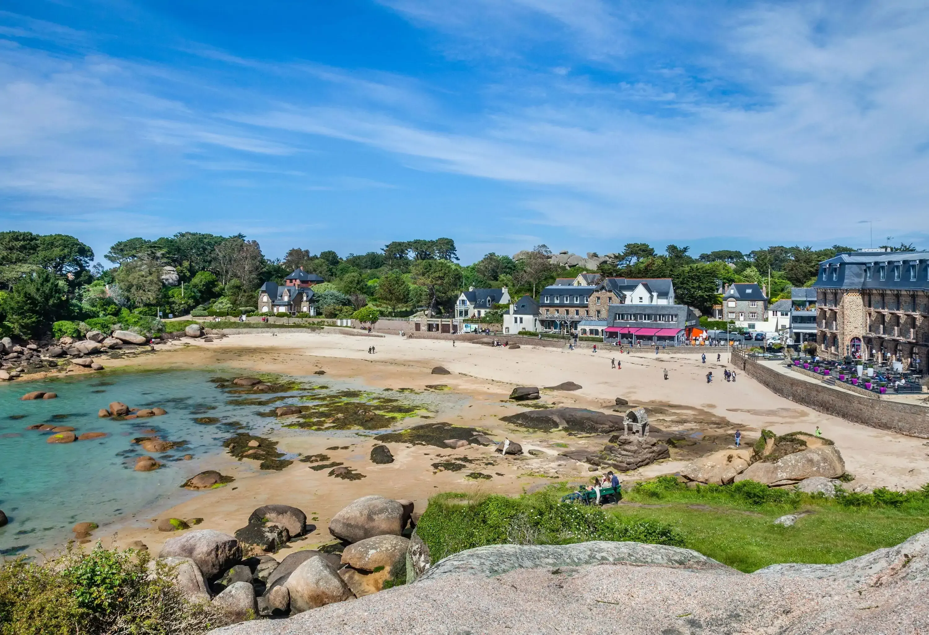 High angle view of a sandy beach with rocks and people