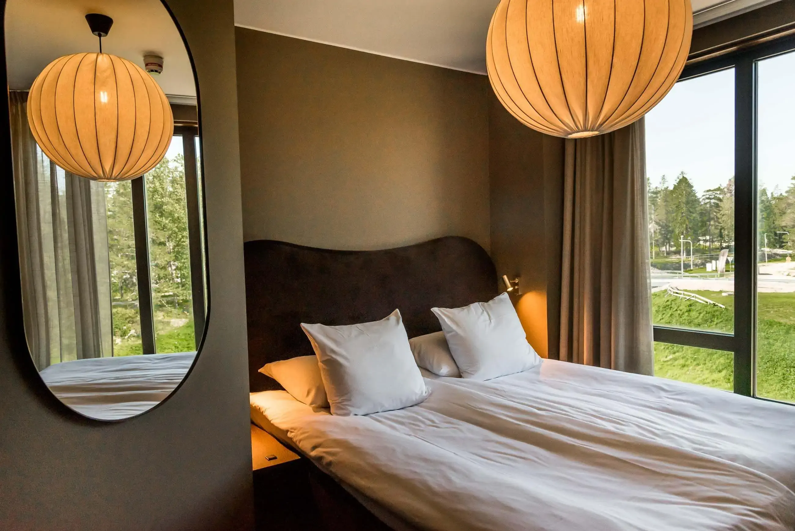 Modern cozy hotel room with view over a garden
