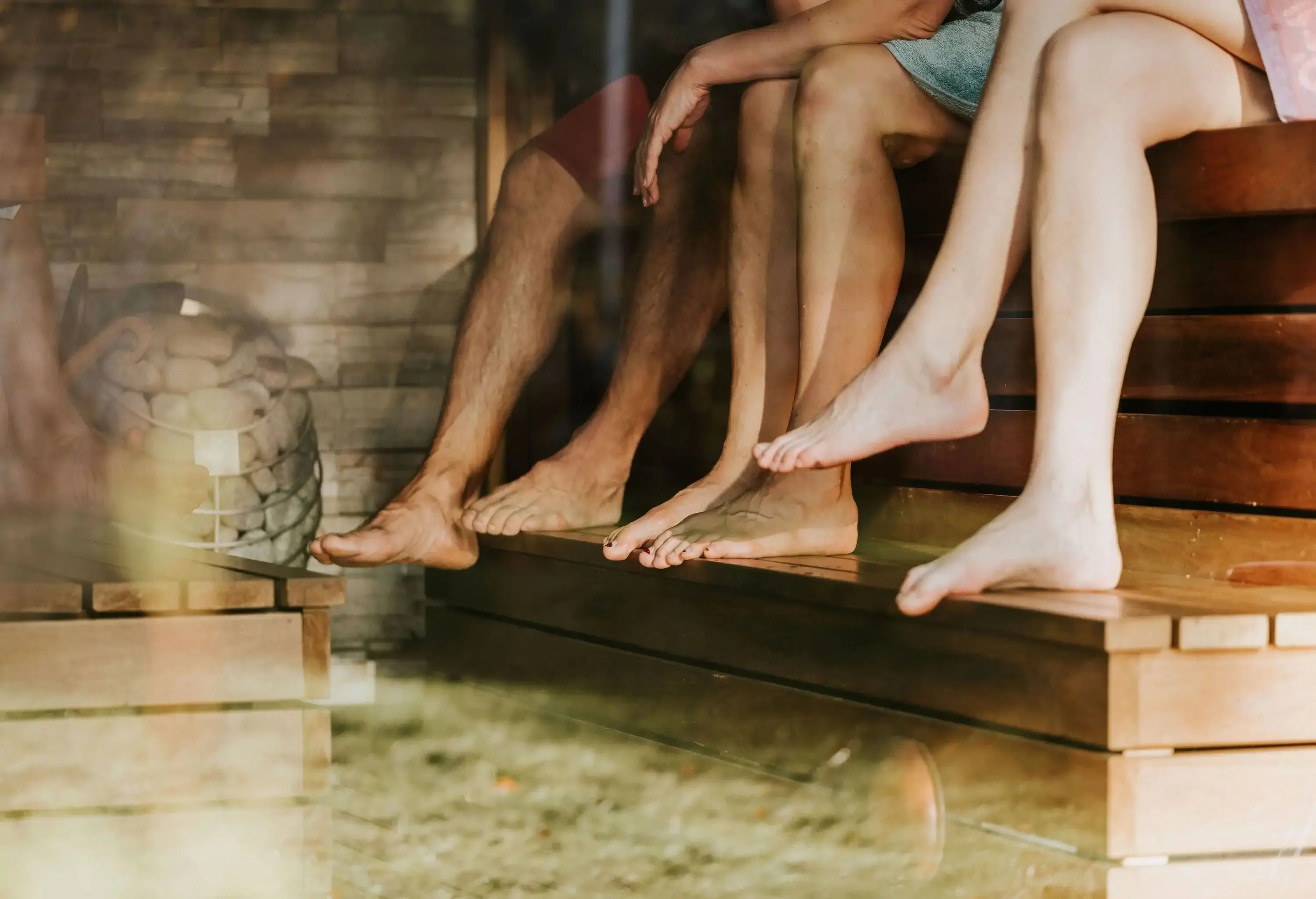 A view of the legs of a group of friends as they sit and enjoy a day of relaxation at the spa.