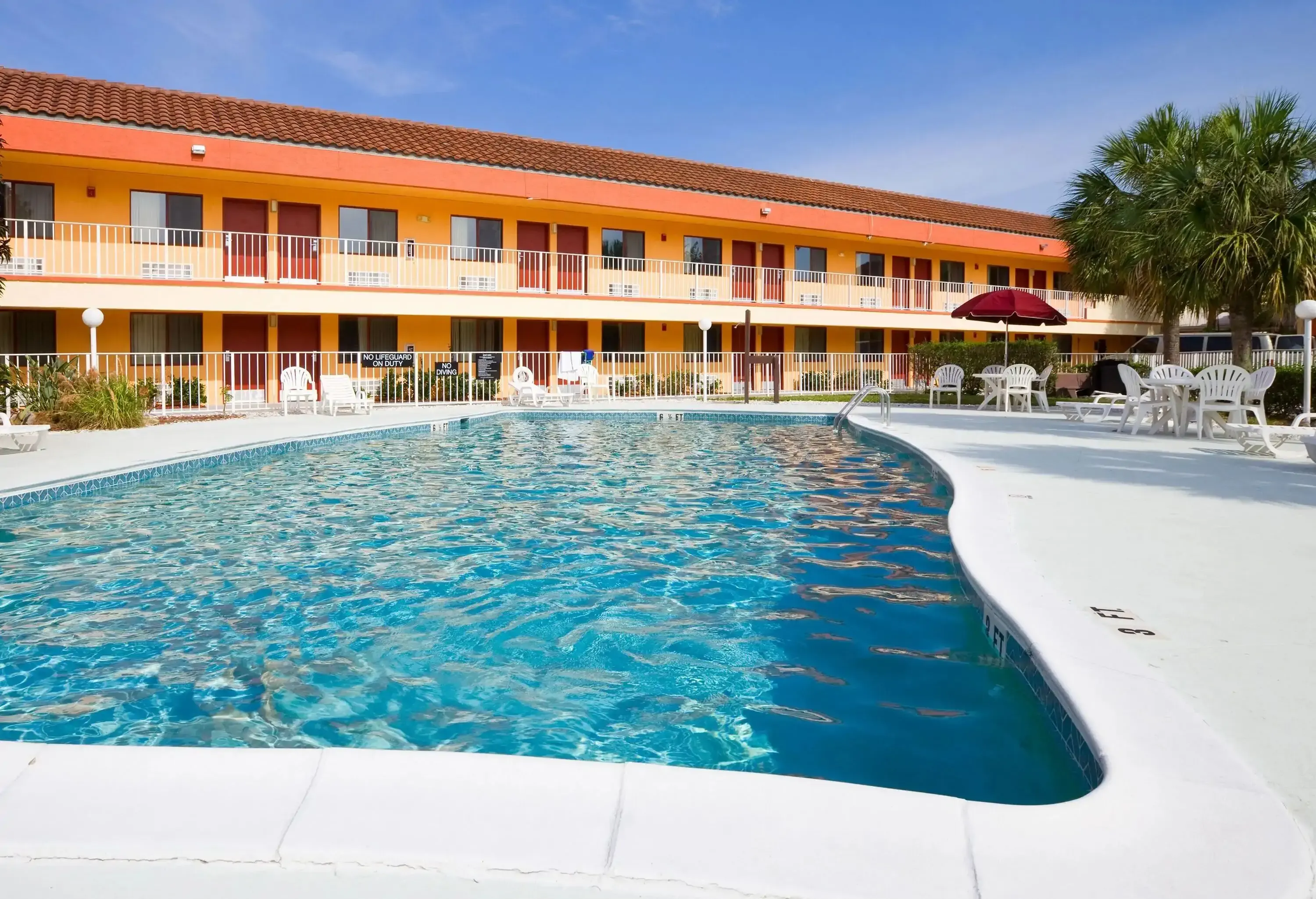 Young woman standing in hotel swimming pool