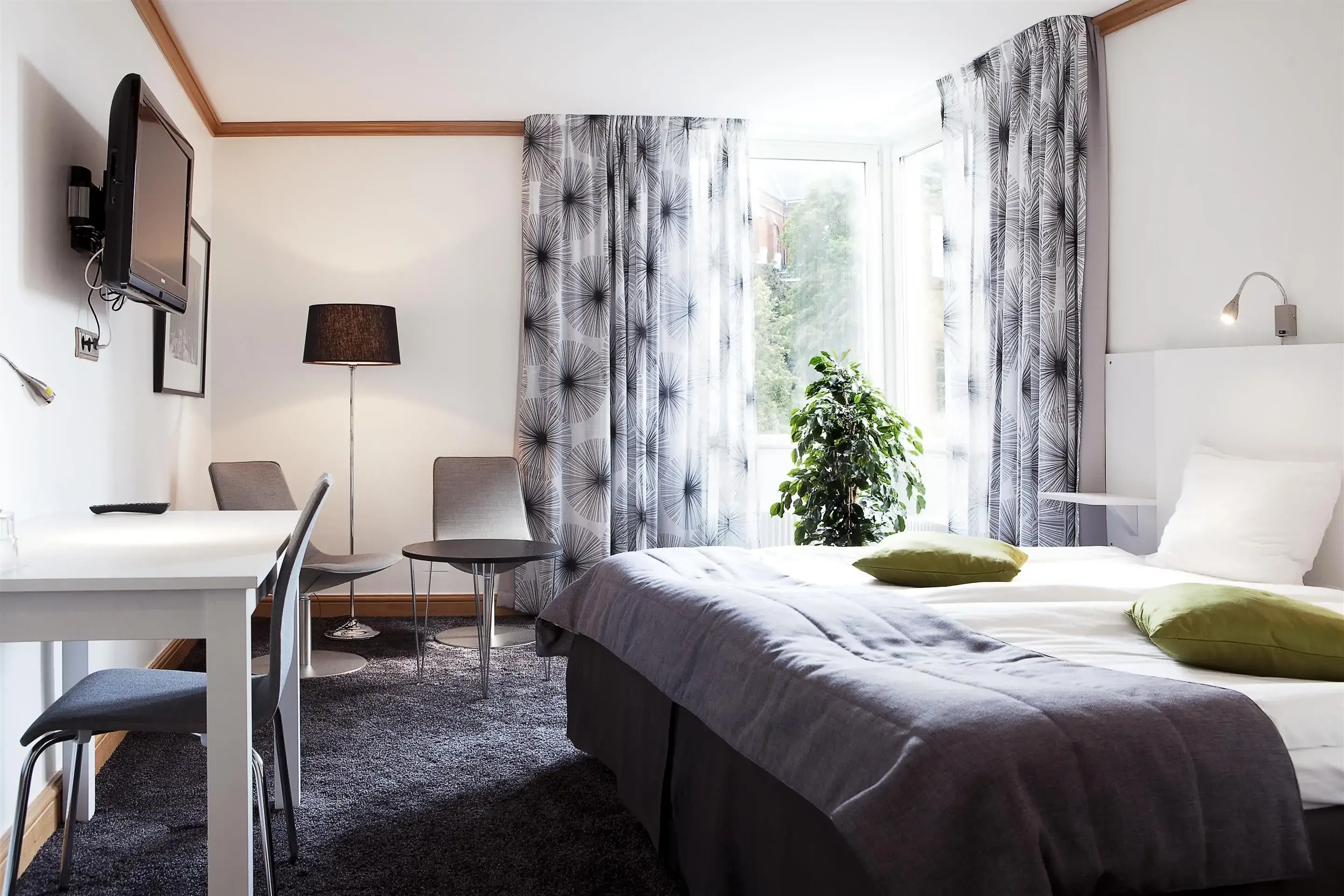 Simple hotel room decorated in muted tones