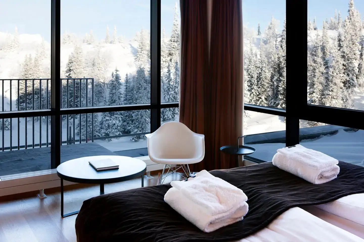 Hotel room with view over snow covered forest
