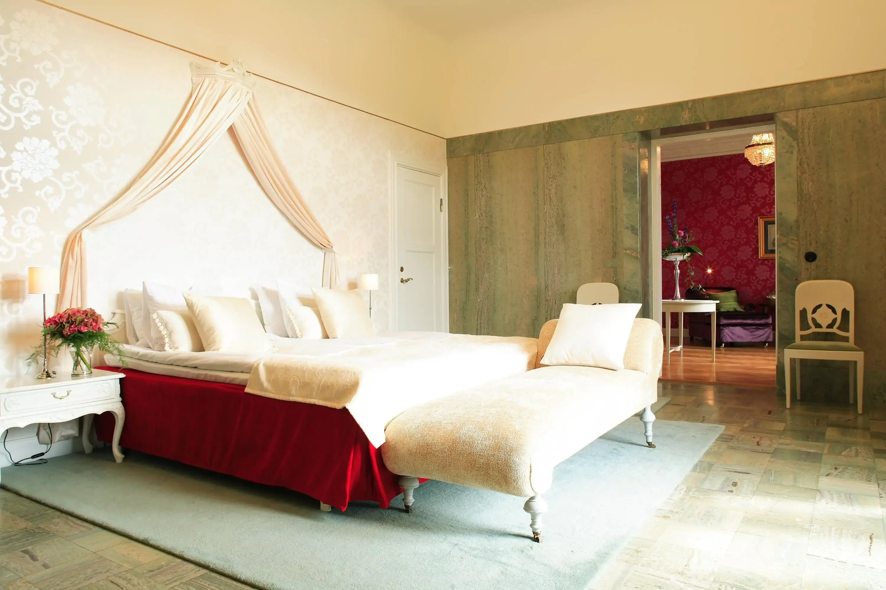 Traditional castle stay hotel room with red bed and canopy