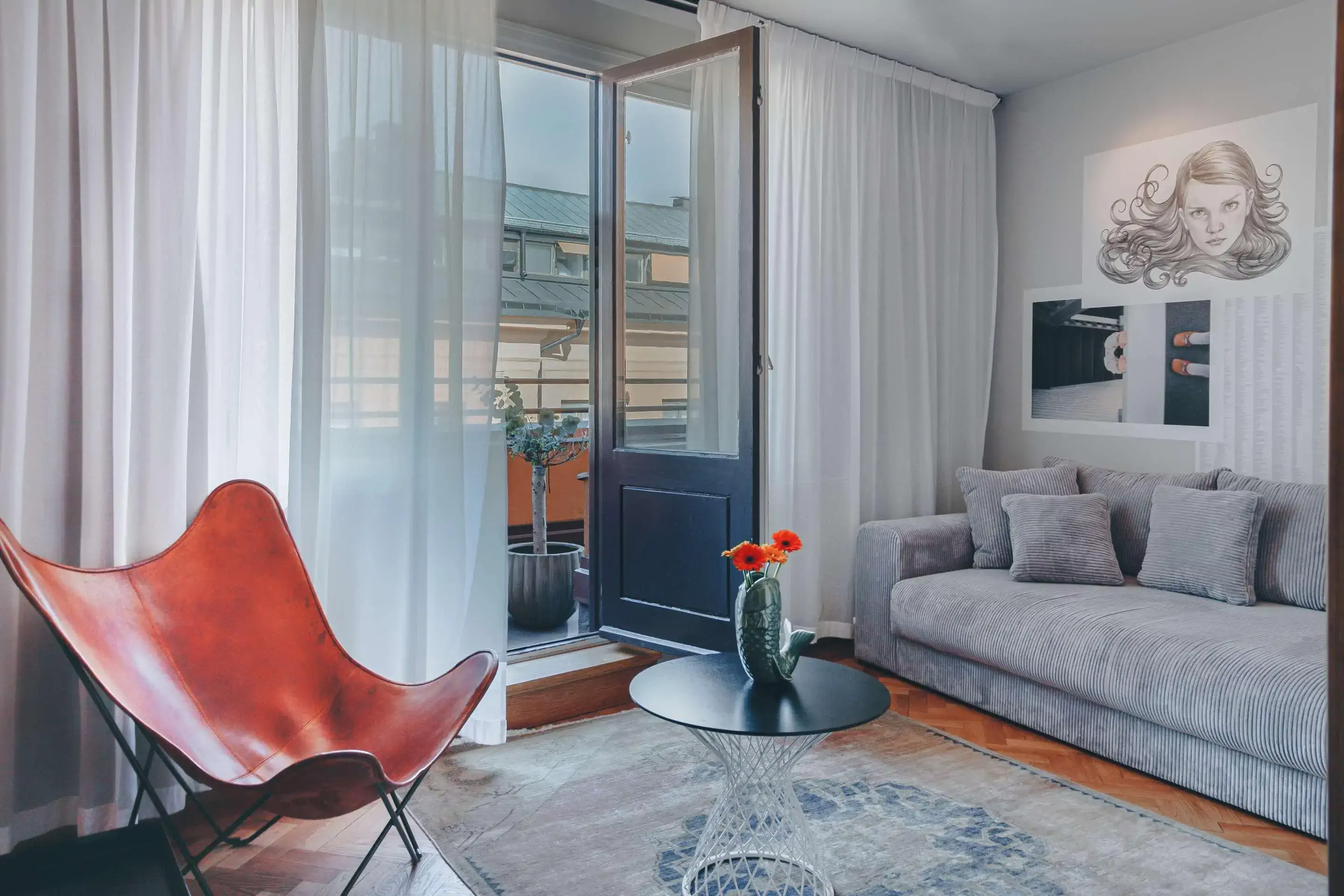 Hotel room lounge with view over city and artwork