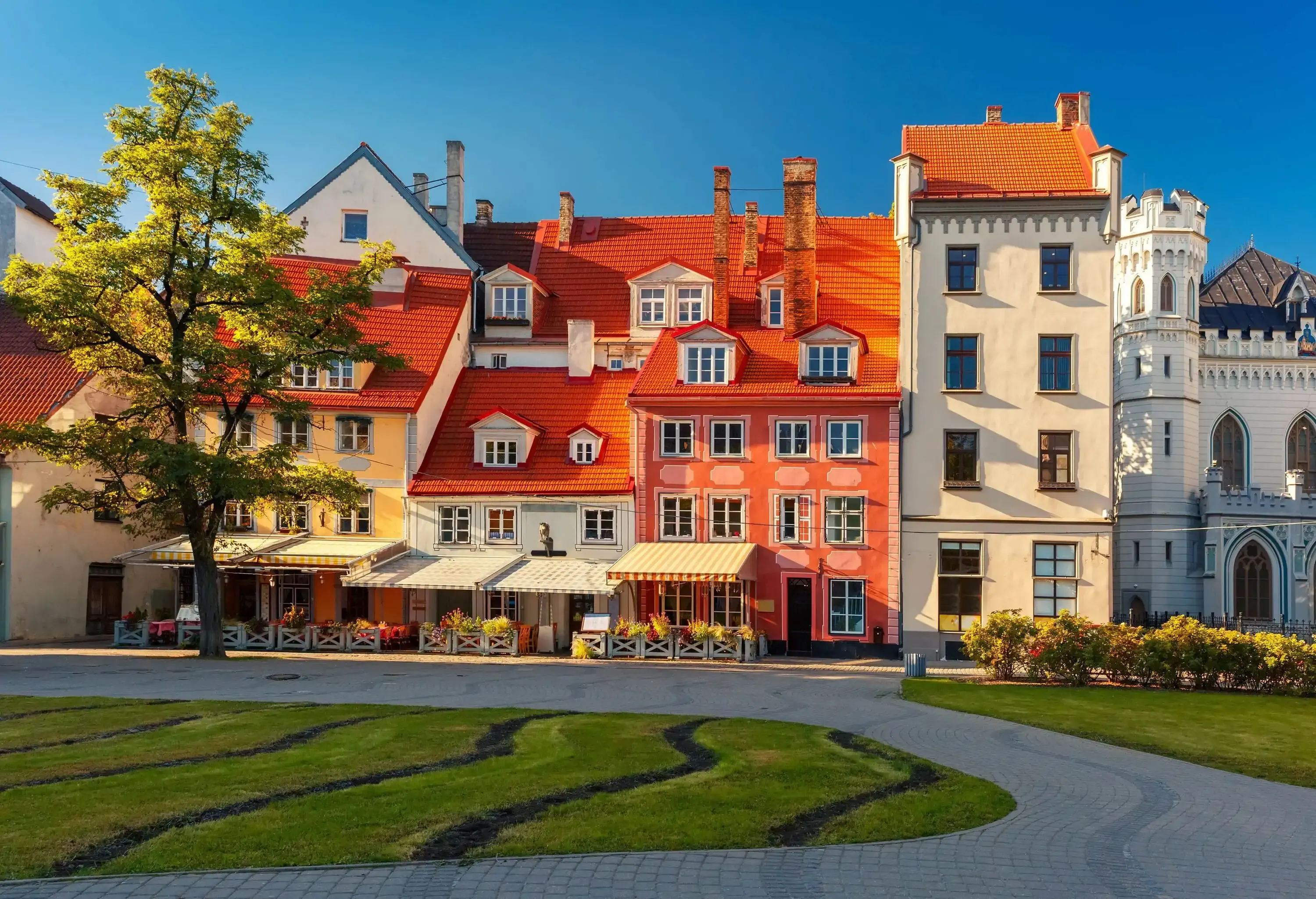 A serene street adorned with charming and brightly coloured vintage houses.