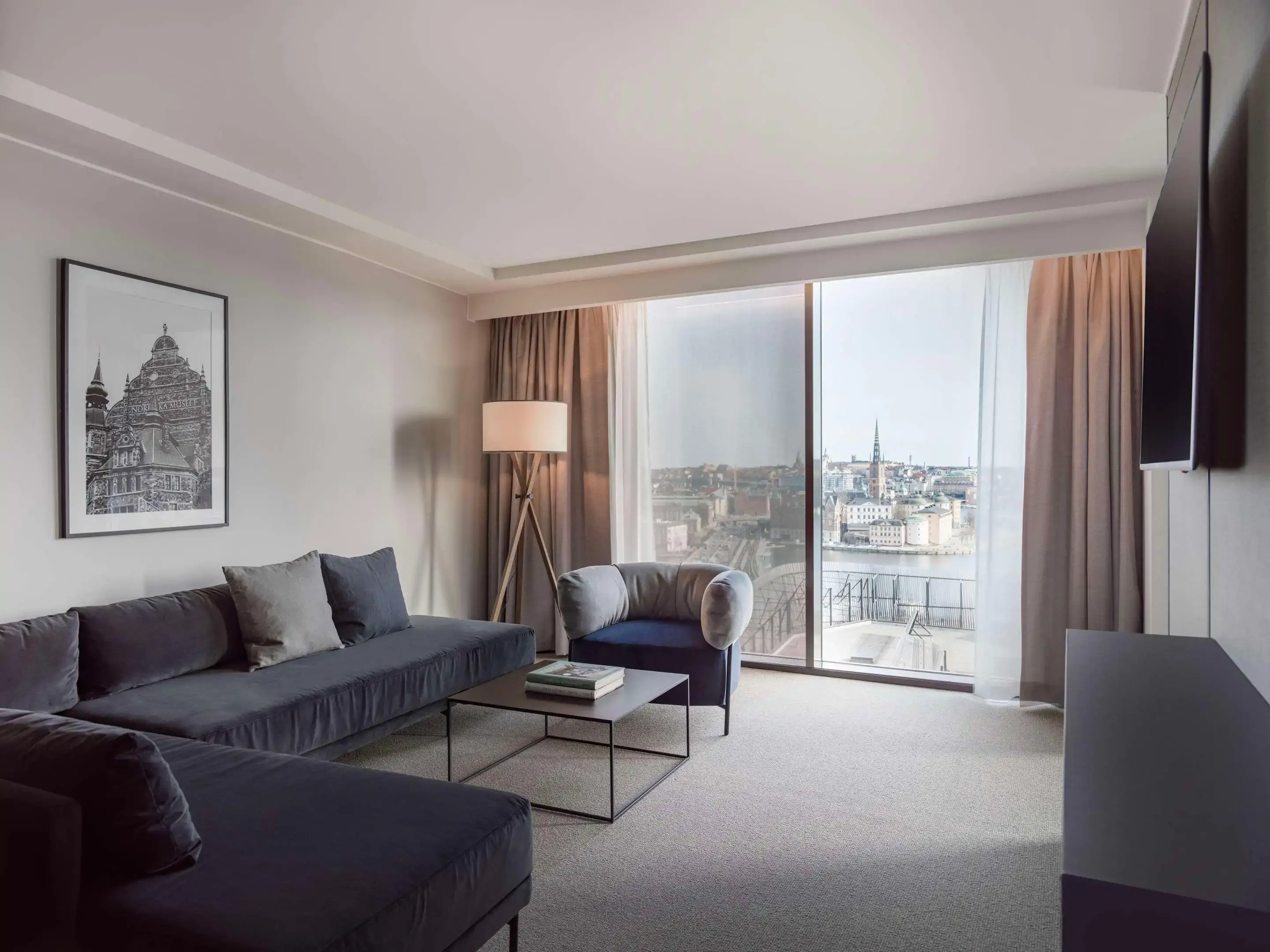 Contemporary minimalist hotel room with view over the river of a city