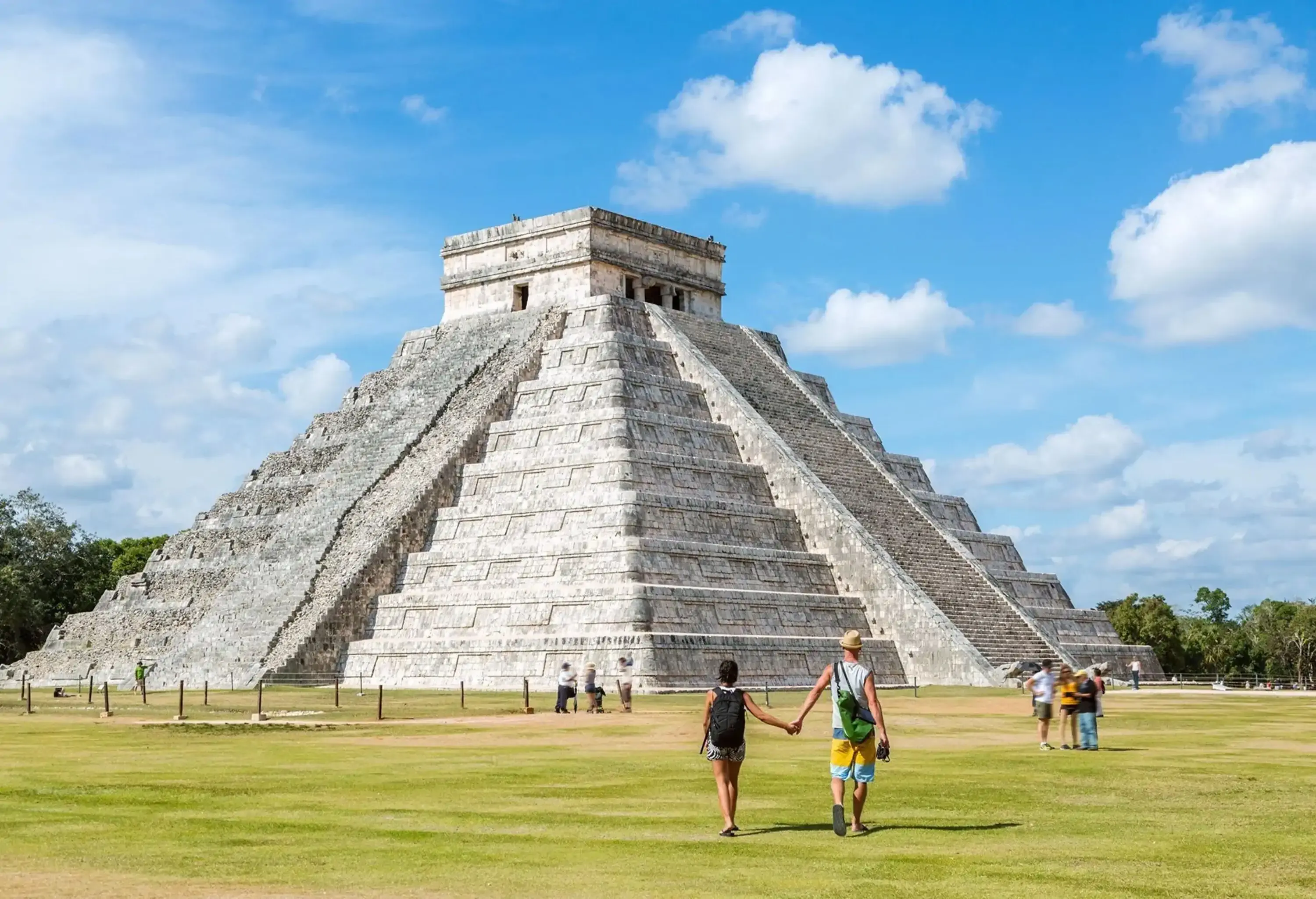 Young Caucasian heterosexual couple on the background of Chichen Itza pyramid in Mexico