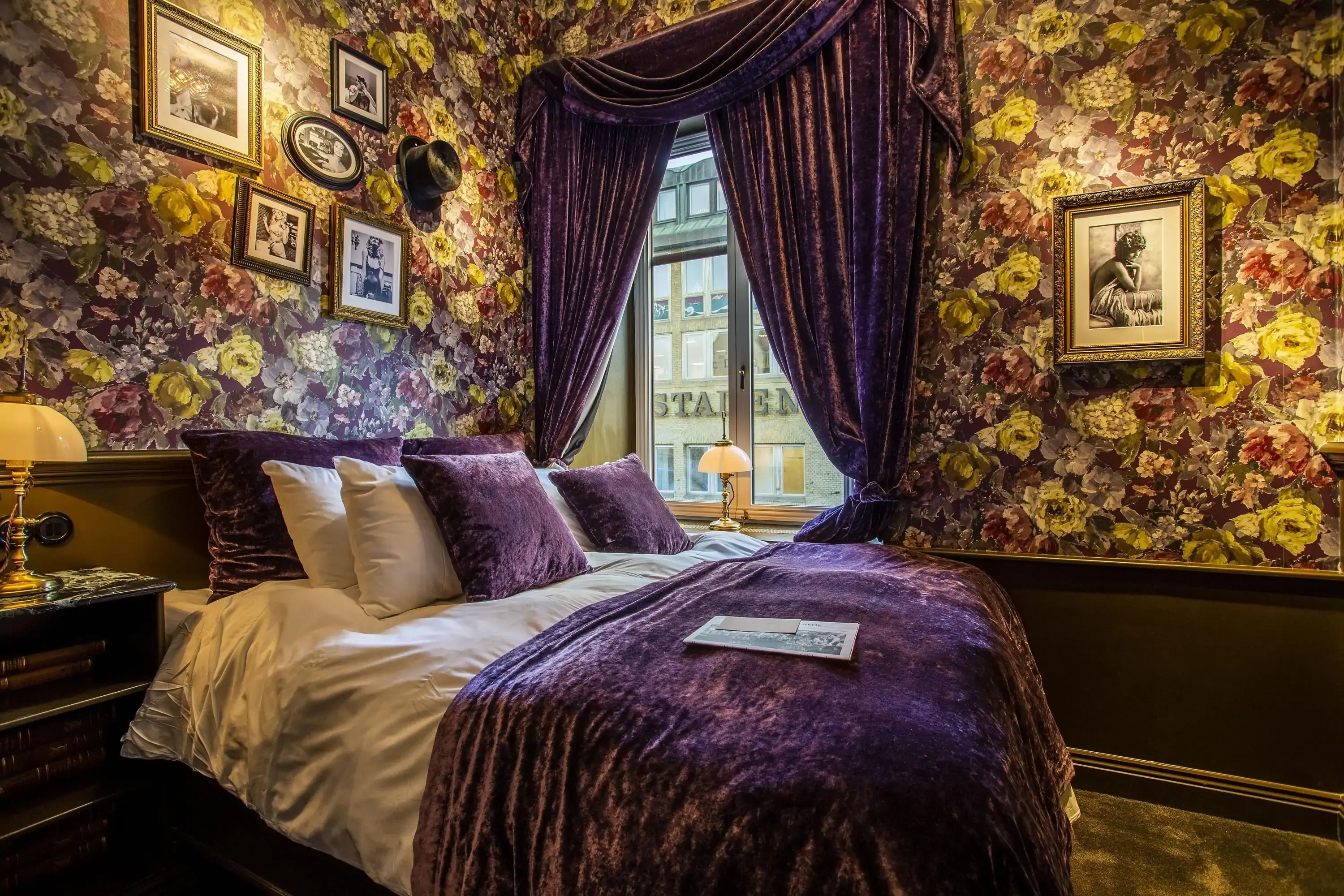 Lavishly decorated pet-friendly hotel room in dark tones and floral wallpaper