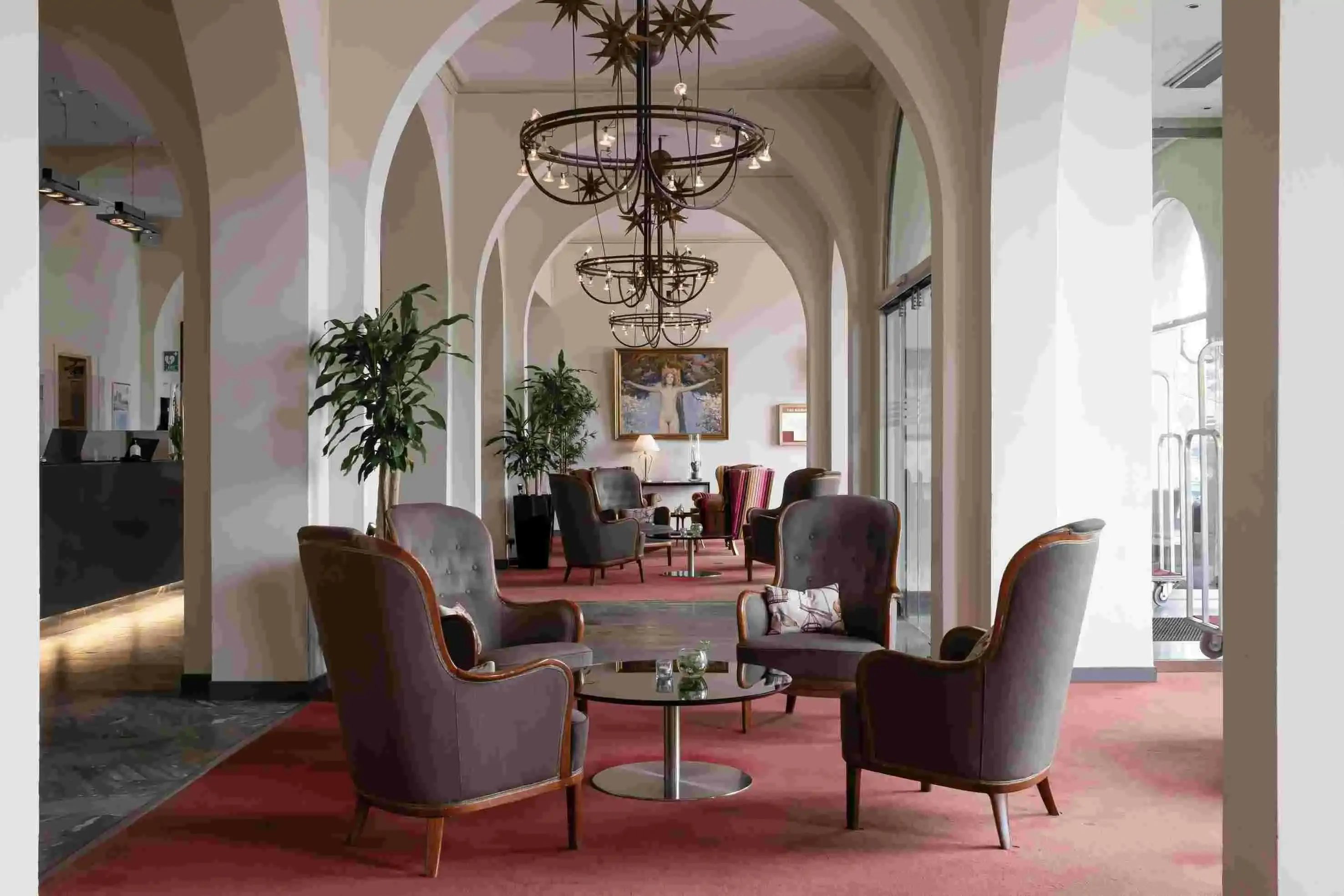 Hotel lounge of an old building with arches and giant chandeliers