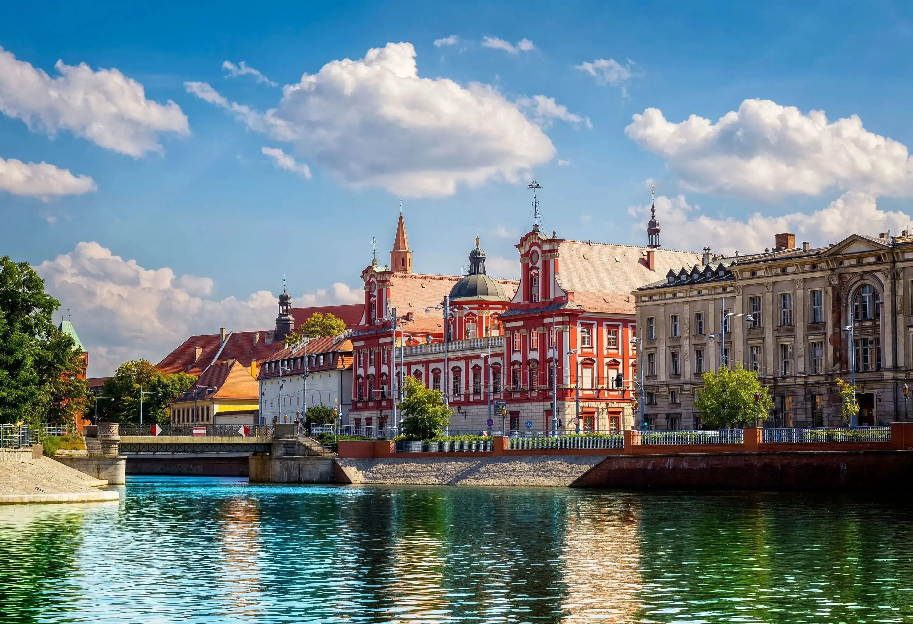 Elegant historic buildings lying on the banks of a river.
