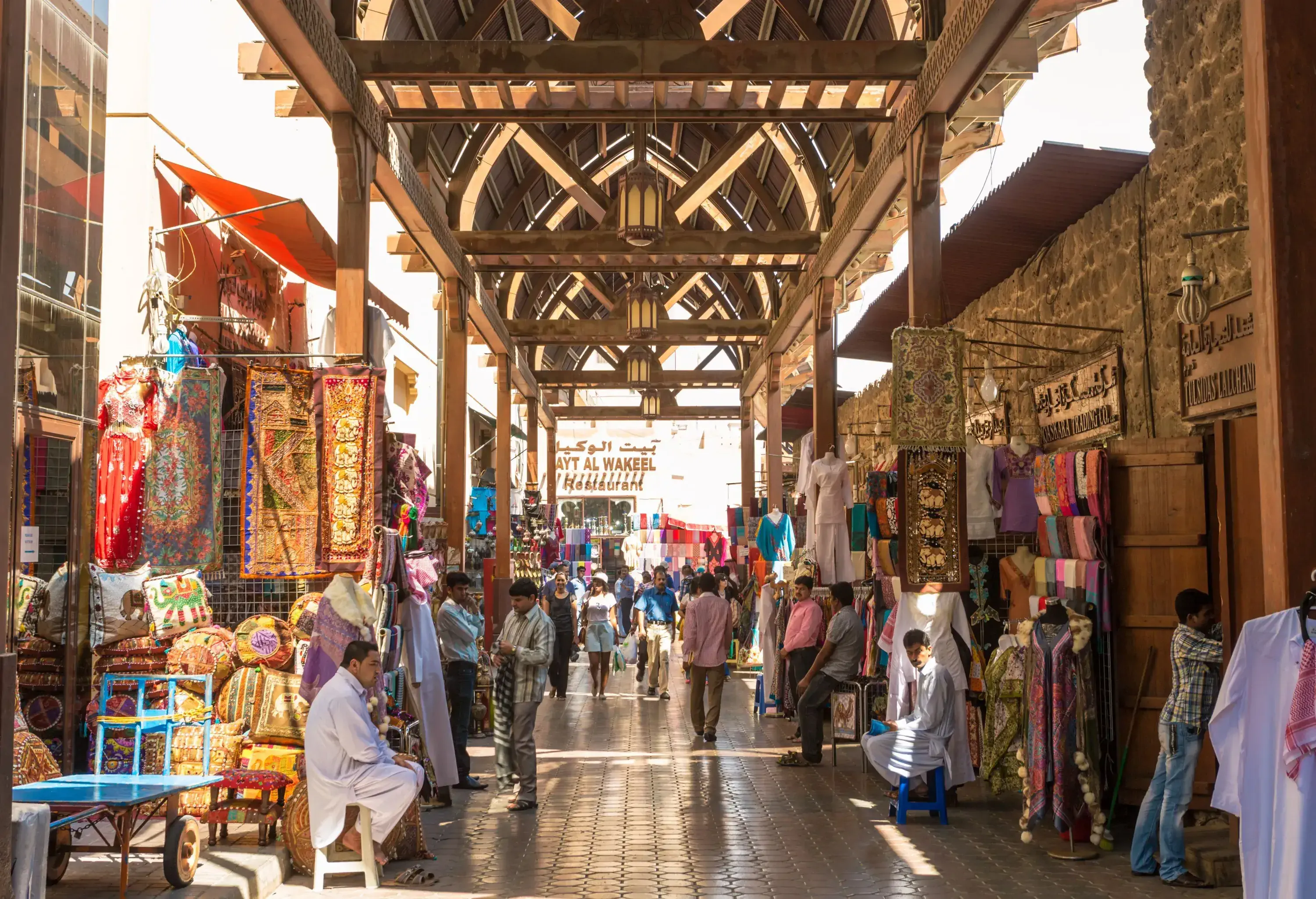 A bustling market gallery selling multicoloured textiles hung from store walls.