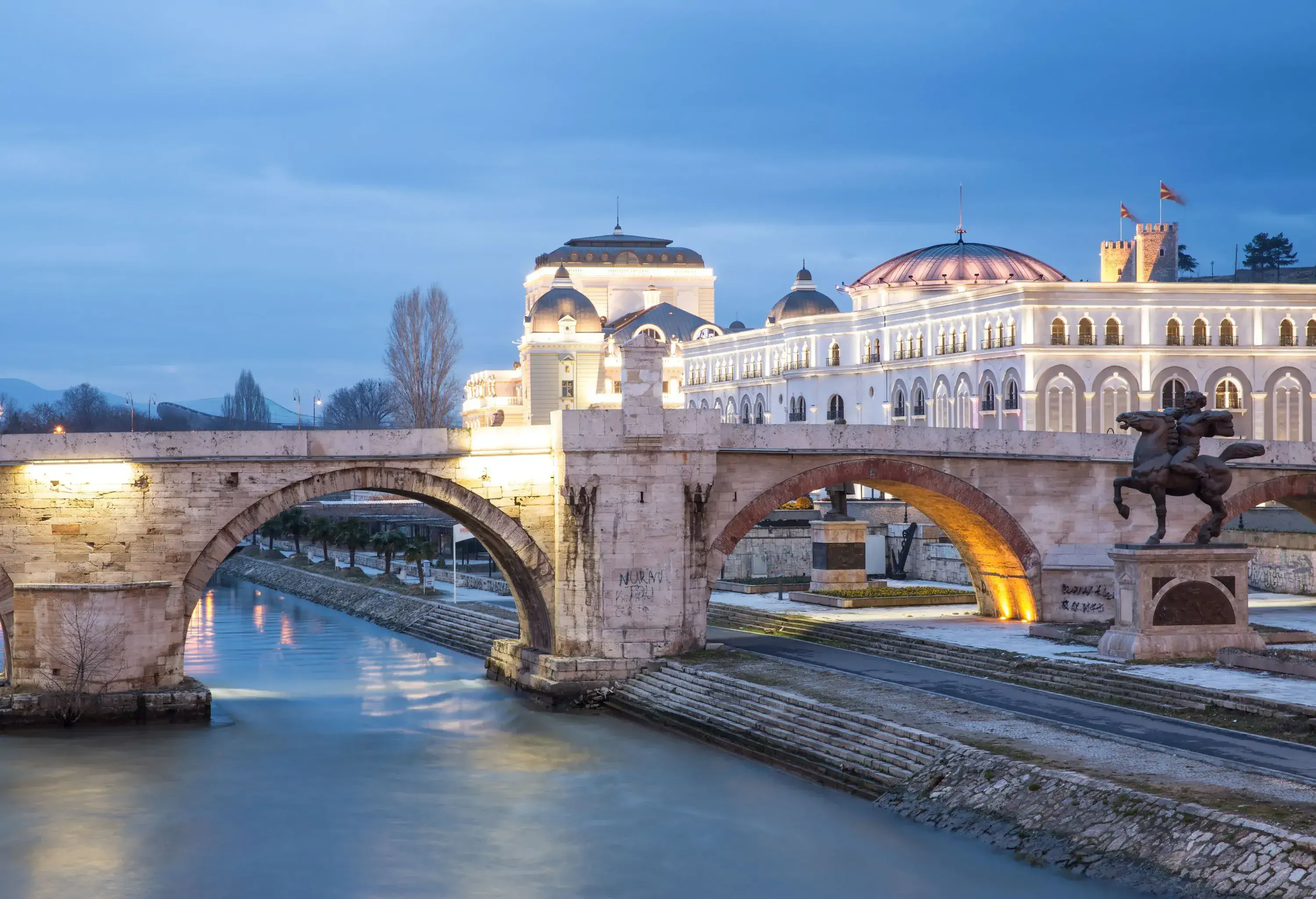 The Stone Bridge across the Vardar River in Skopje, with beautiful architecture in the background.