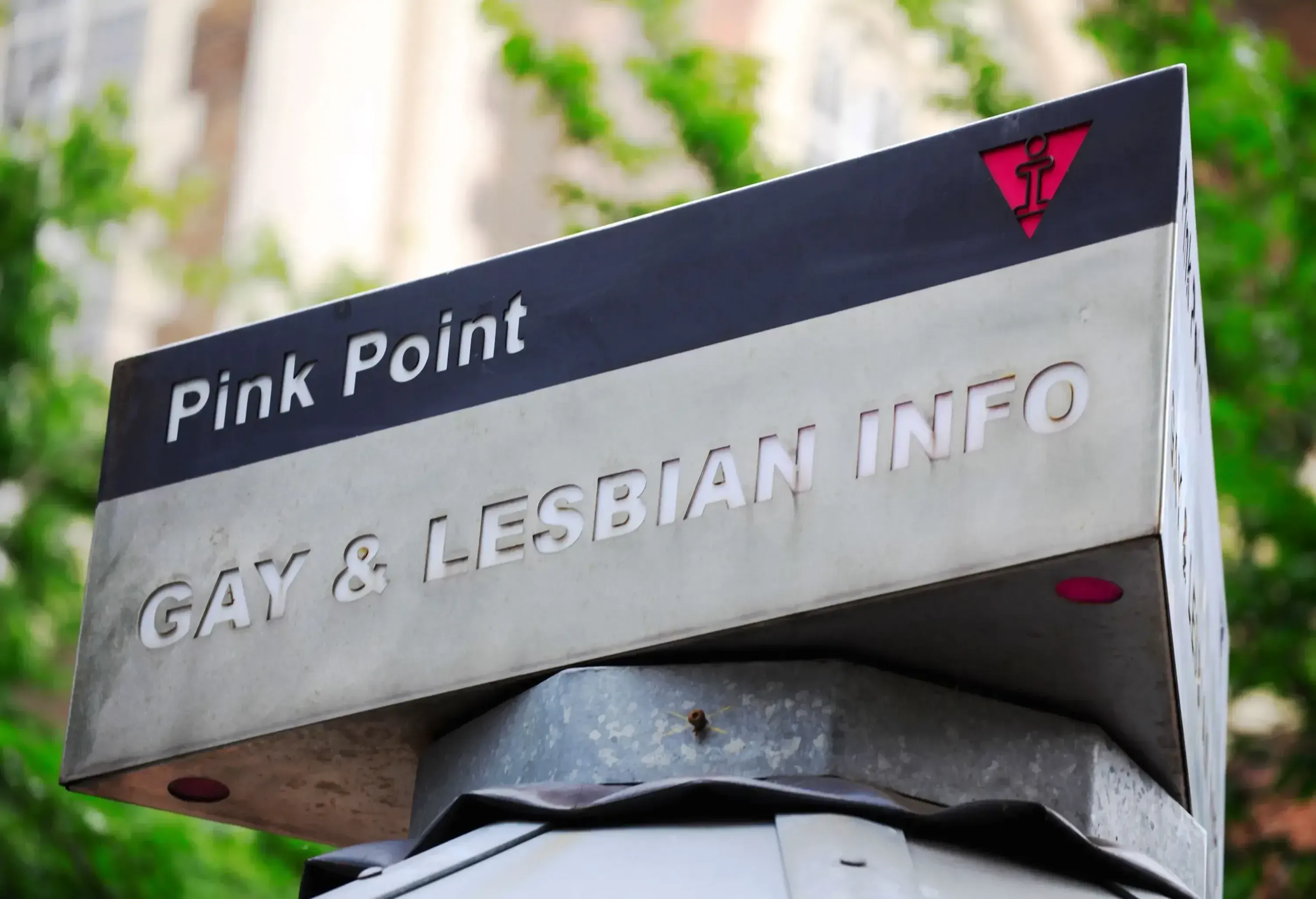 A pink point signage, a gay and lesbian information kiosk.