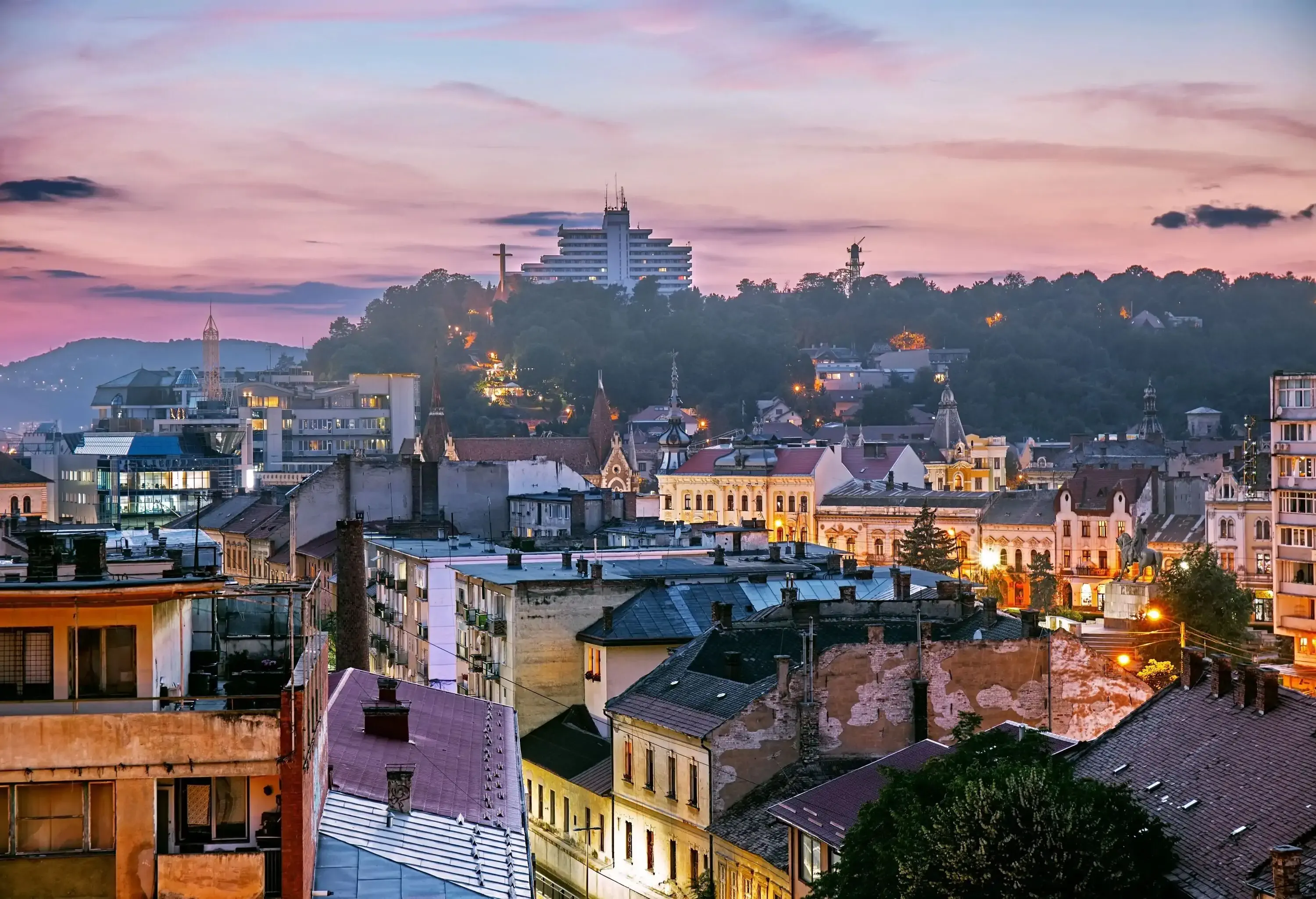 A charming townscape nestled amidst trees, with a building discreetly peeking from behind the lush foliage.